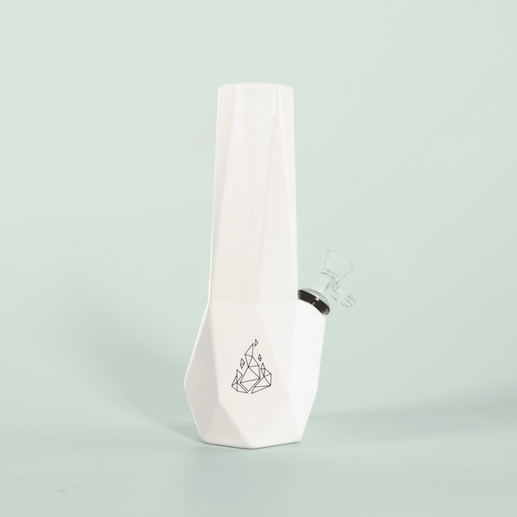 White ceramic Hexagon bong by BRNT Designs, base is a hexagon shape. Opaque, making it easy to leave out and not look like a cannabis accessory product. 