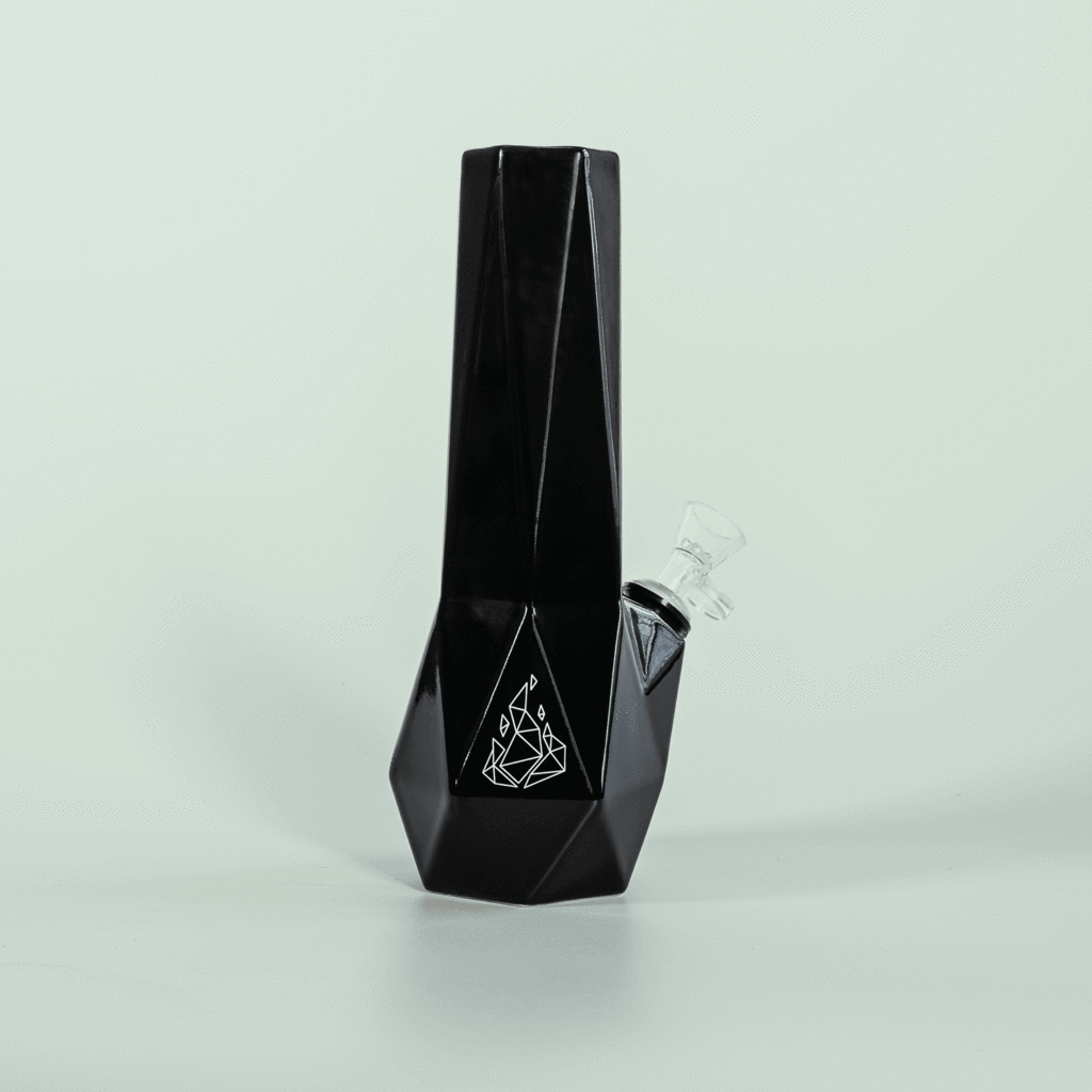 Ceramic minimalist water bong in black. Base is a Hexagon shape with BRNT logo on front. 